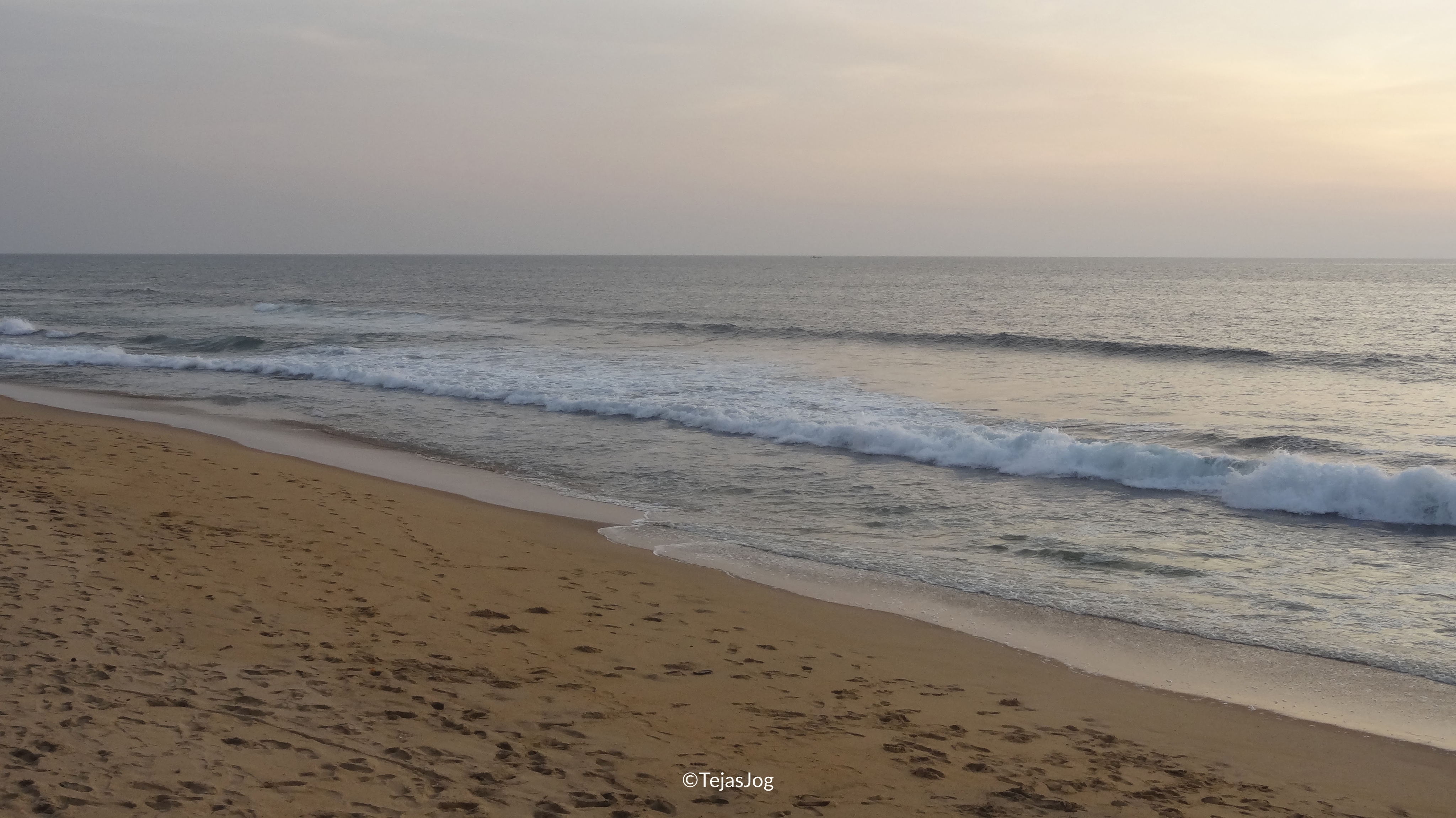Waves crashing on the shore at dusk