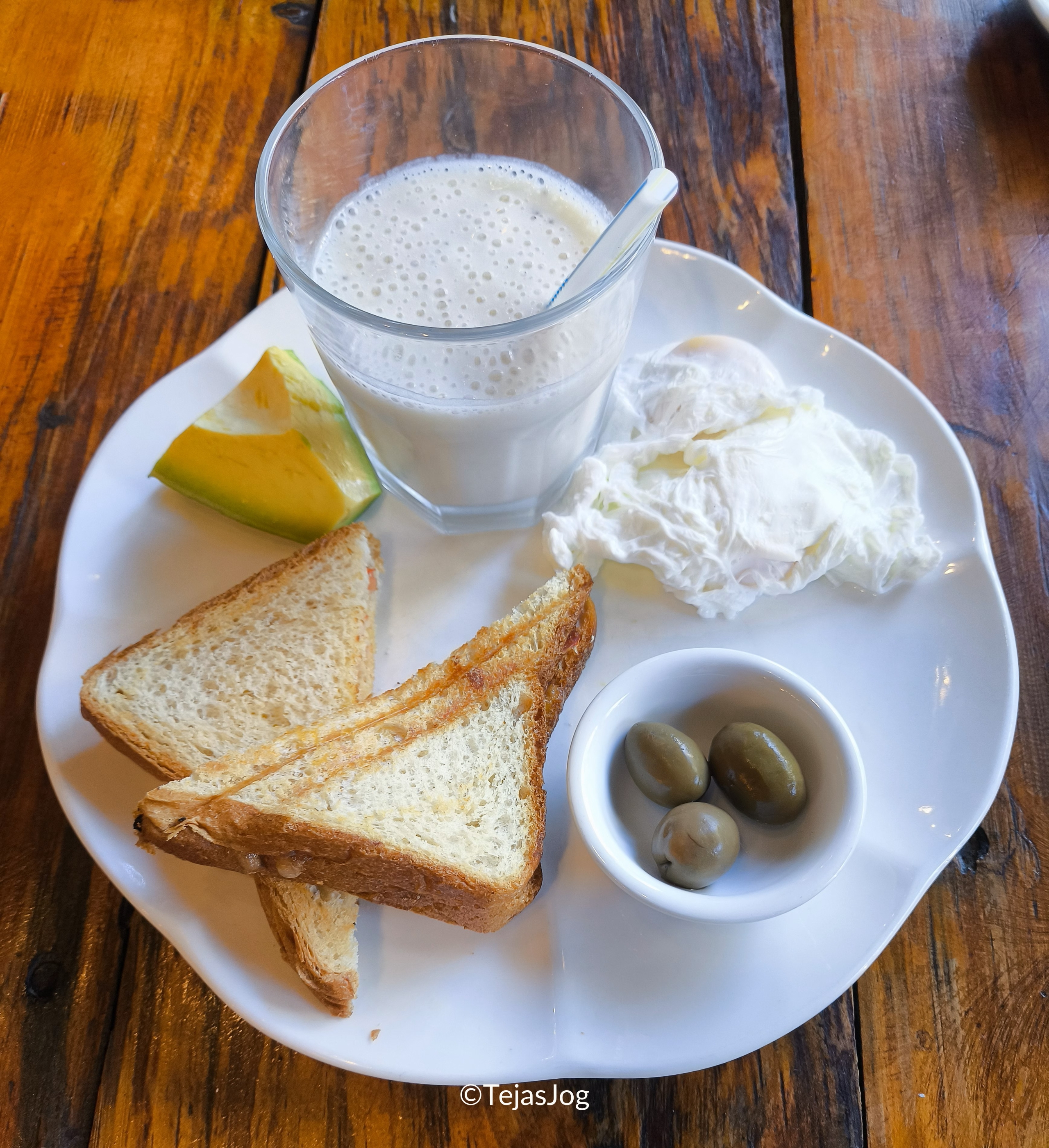 Hot sandwich with mozzarella cheese, Visheti (local cake), a banana milkshake, olives, and avocado